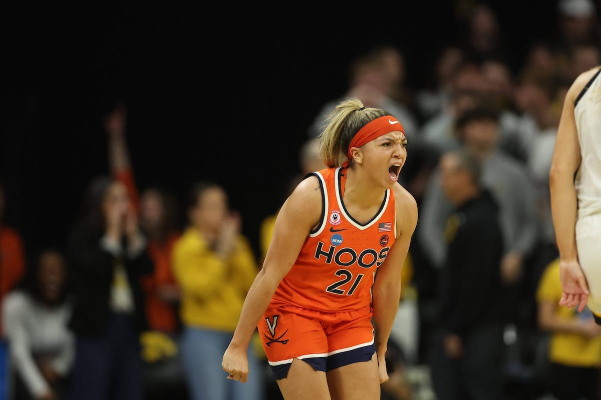 A women's basketball player screams in excitement.